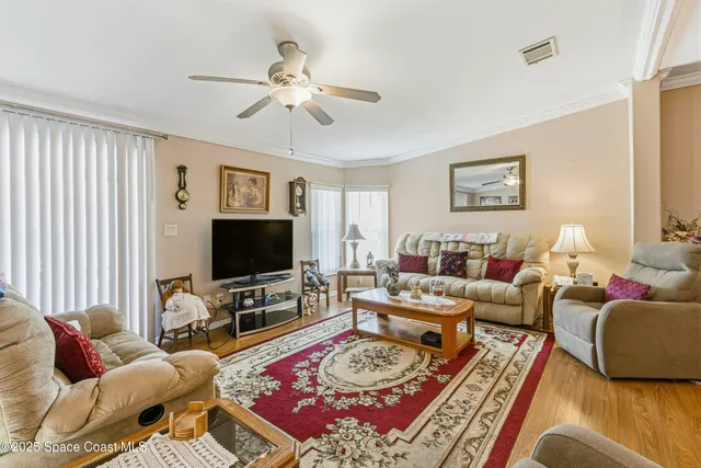 a living room with furniture a rug and a flat screen tv