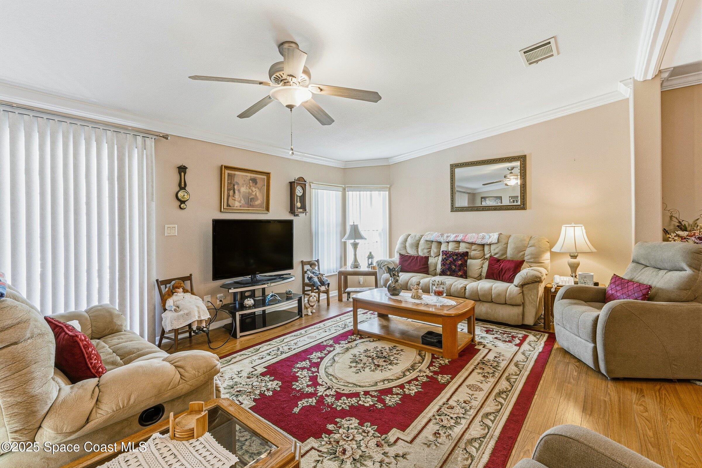 595 Outer Drive, Unit 129 Cocoa, FL 32926 - Photo 13 of 49 a living room with furniture a rug and a flat screen tv