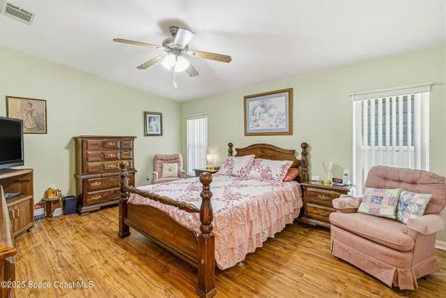 a bedroom with a bed and a couch