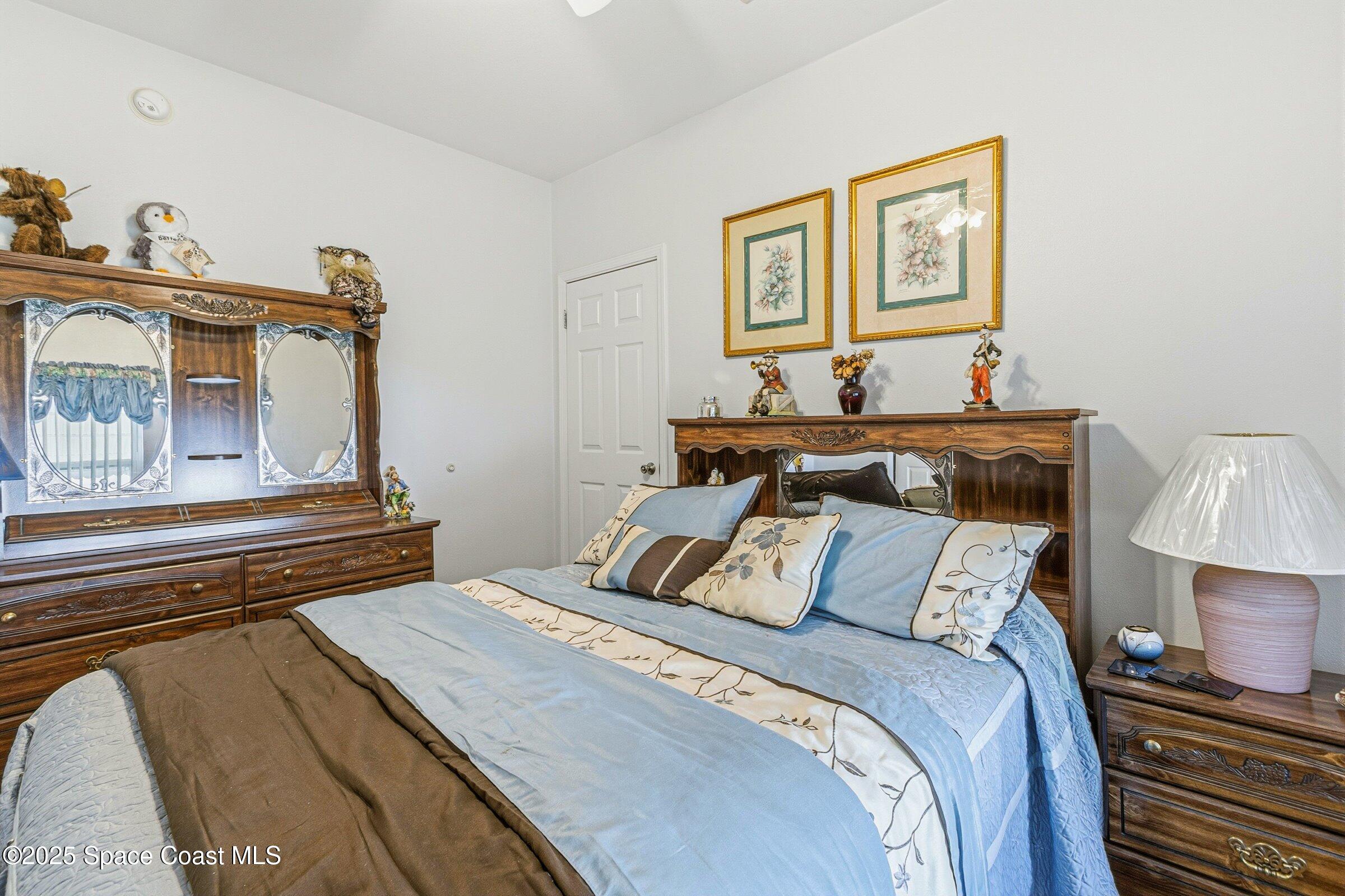 595 Outer Drive, Unit 129 Cocoa, FL 32926 - Photo 16 of 49 a bedroom with a bed and a night stand