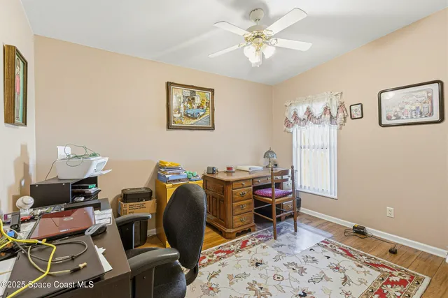 a view of a workspace with furniture and wooden floor
