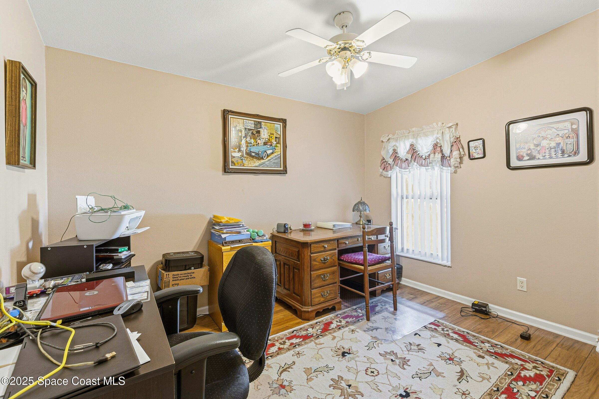 595 Outer Drive, Unit 129 Cocoa, FL 32926 - Photo 18 of 49 a view of a workspace with furniture and wooden floor