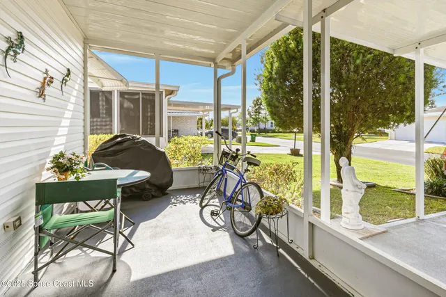 a view of a chairs and table in patio with a backyard