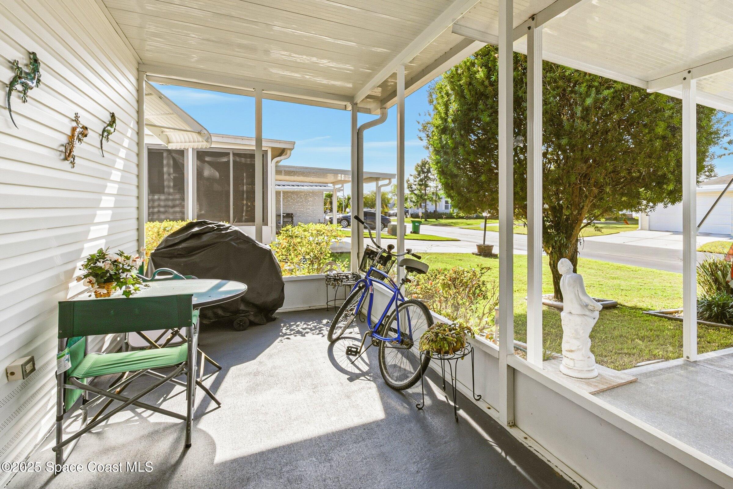 595 Outer Drive, Unit 129 Cocoa, FL 32926 - Photo 21 of 49 a view of a chairs and table in patio with a backyard