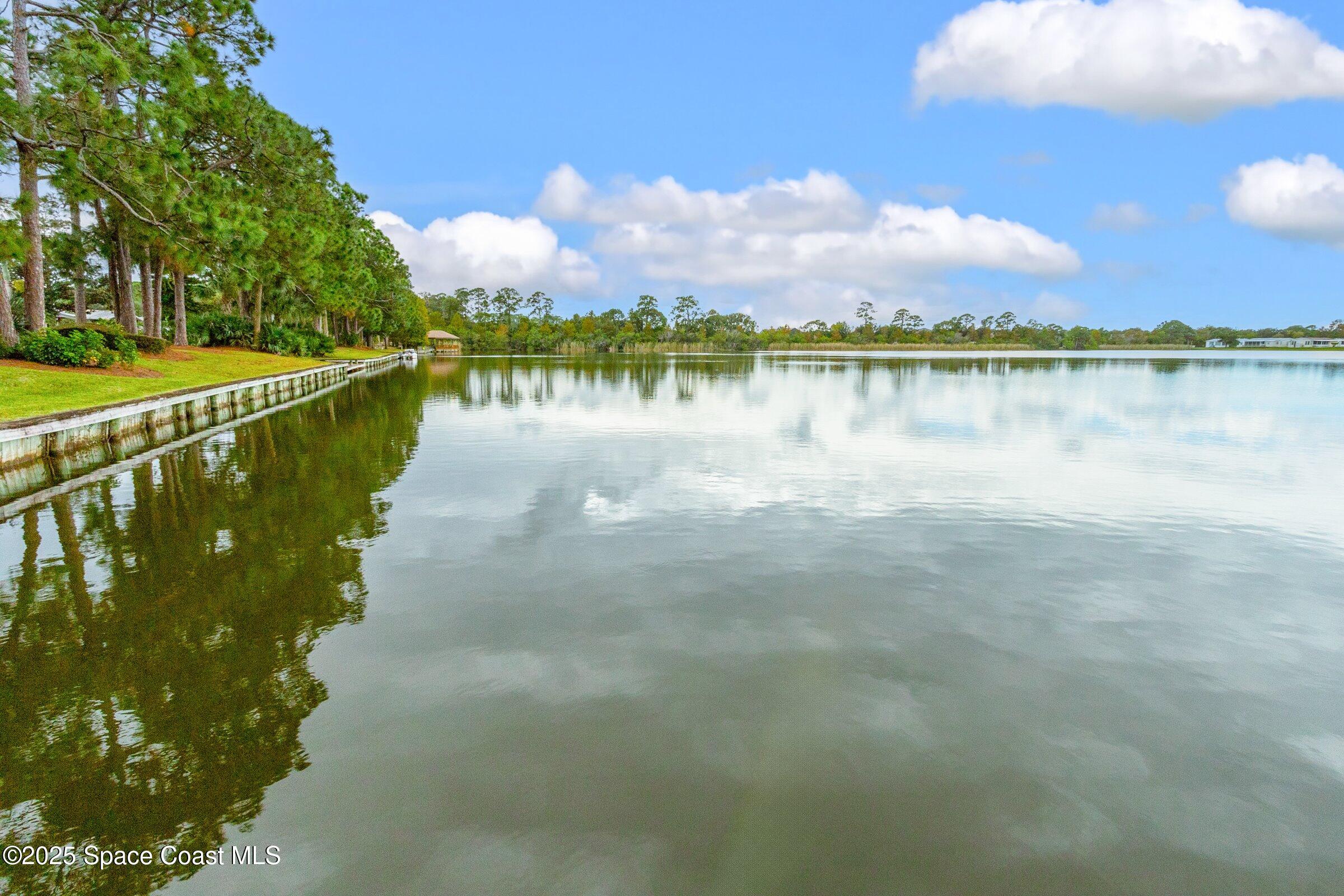 595 Outer Drive, Unit 129 Cocoa, FL 32926 - Photo 29 of 49 a view of a lake with a city