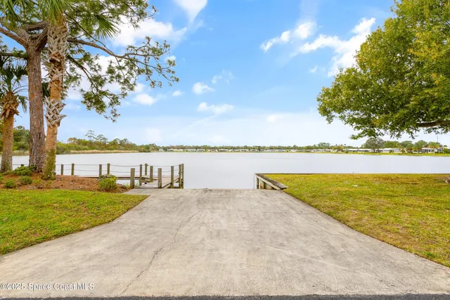 a view of a lake with a table and chairs