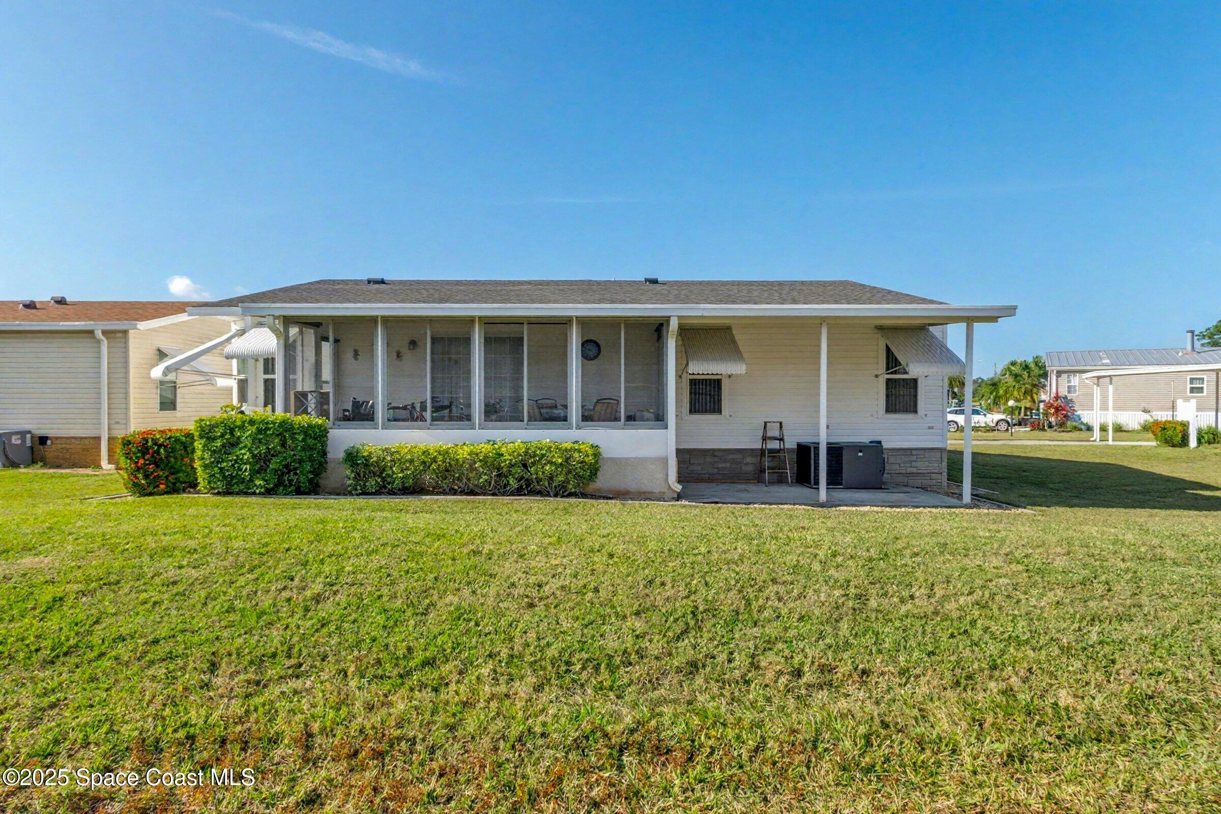 595 Outer Drive, Unit 129 Cocoa, FL 32926 - Photo 5 of 49 a view of a house with backyard sitting area and garden
