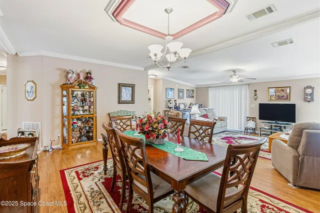 a view of a dining room with furniture and a chandelier