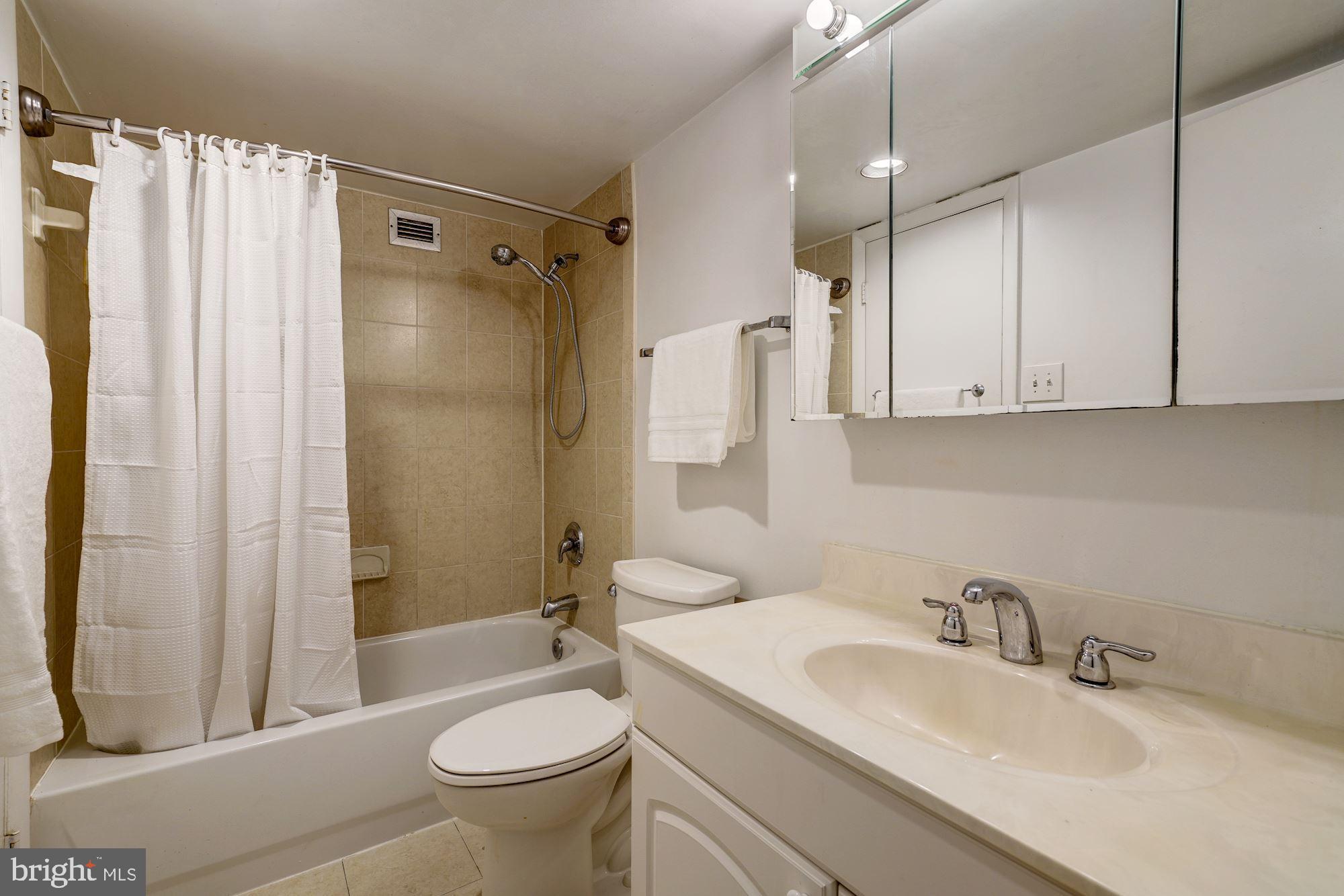 1301 20th Street Northwest, Unit 517 Washington, DC 20036 - Photo 8 of 14 a bathroom with a sink toilet and shower