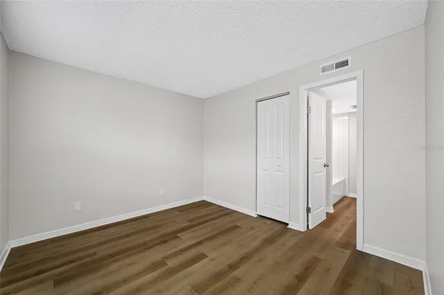 a view of a room with wooden floor and white doors