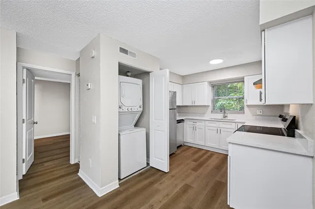 a kitchen with white cabinets and white appliances