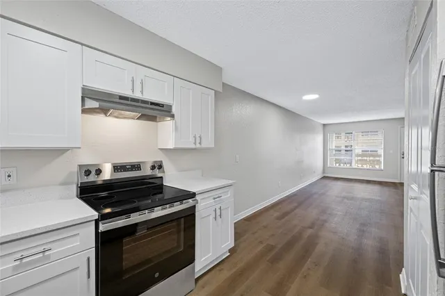 a kitchen with stainless steel appliances a stove and a refrigerator