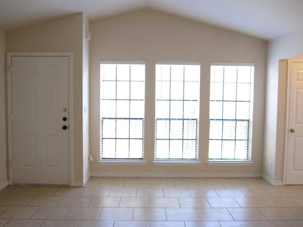 8811 Clearbrook Trail Austin, TX 78729 - Photo 35 of 38 lft A - An open floorplan with vaulted ceilings and abundant natural light from multiple windows.