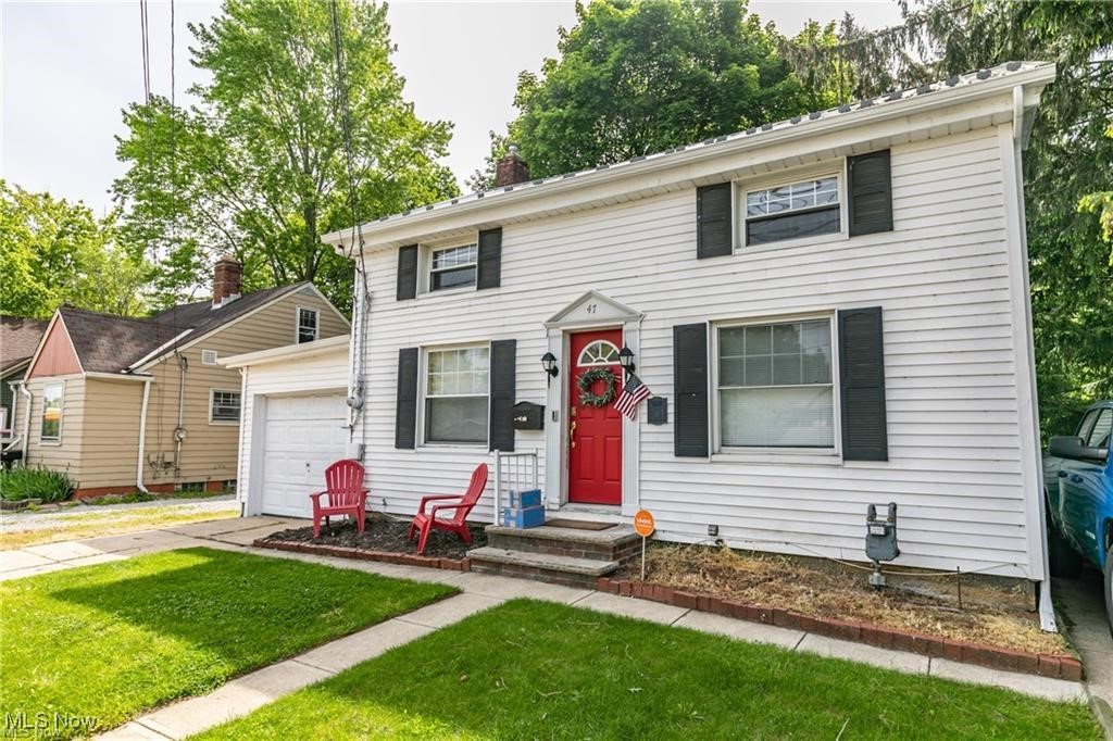 47 Prospect Road Berea, OH 44017 - Photo 1 of 23 Colonial house featuring a garage, a front lawn, and a chimney