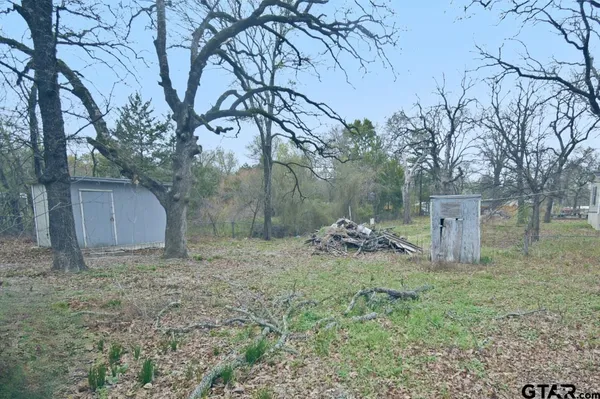 a wooden fence with a trees in the background
