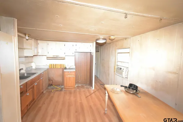 an empty room with chandelier fan