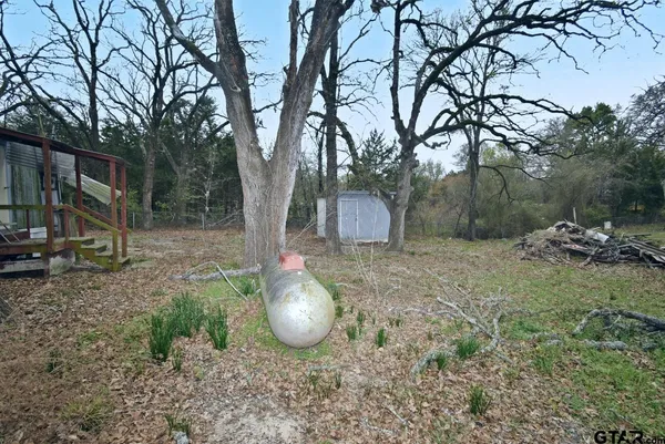 a view of a barn in the middle of a yard