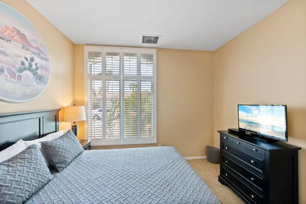 a bedroom with a bed and a flat screen tv