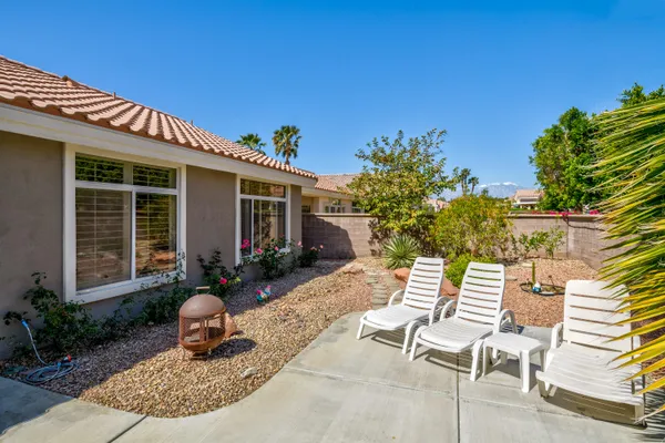 a view of a chair and tables in the patio