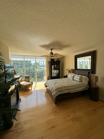 a bedroom with furniture and a large window