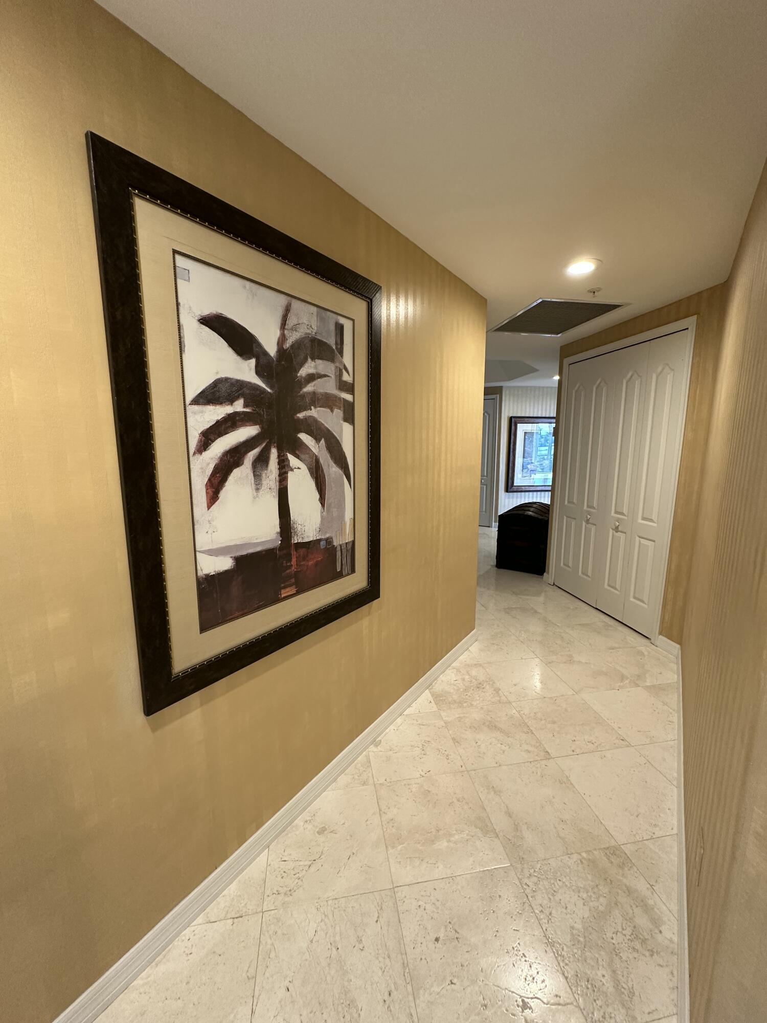 2900 North Hwy A1A, Unit 2 Fort Pierce, FL 34949 - Photo 16 of 34 a view of a hallway with paintings on the wall