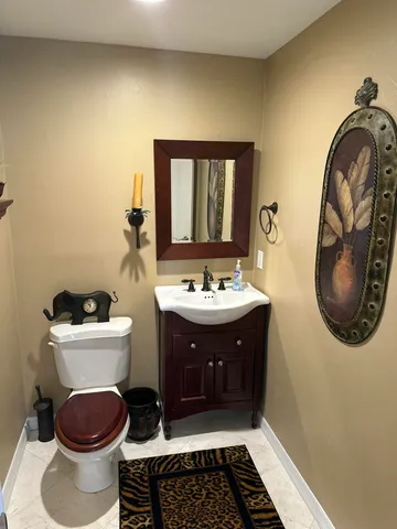 a bathroom with a sink a toilet and mirror