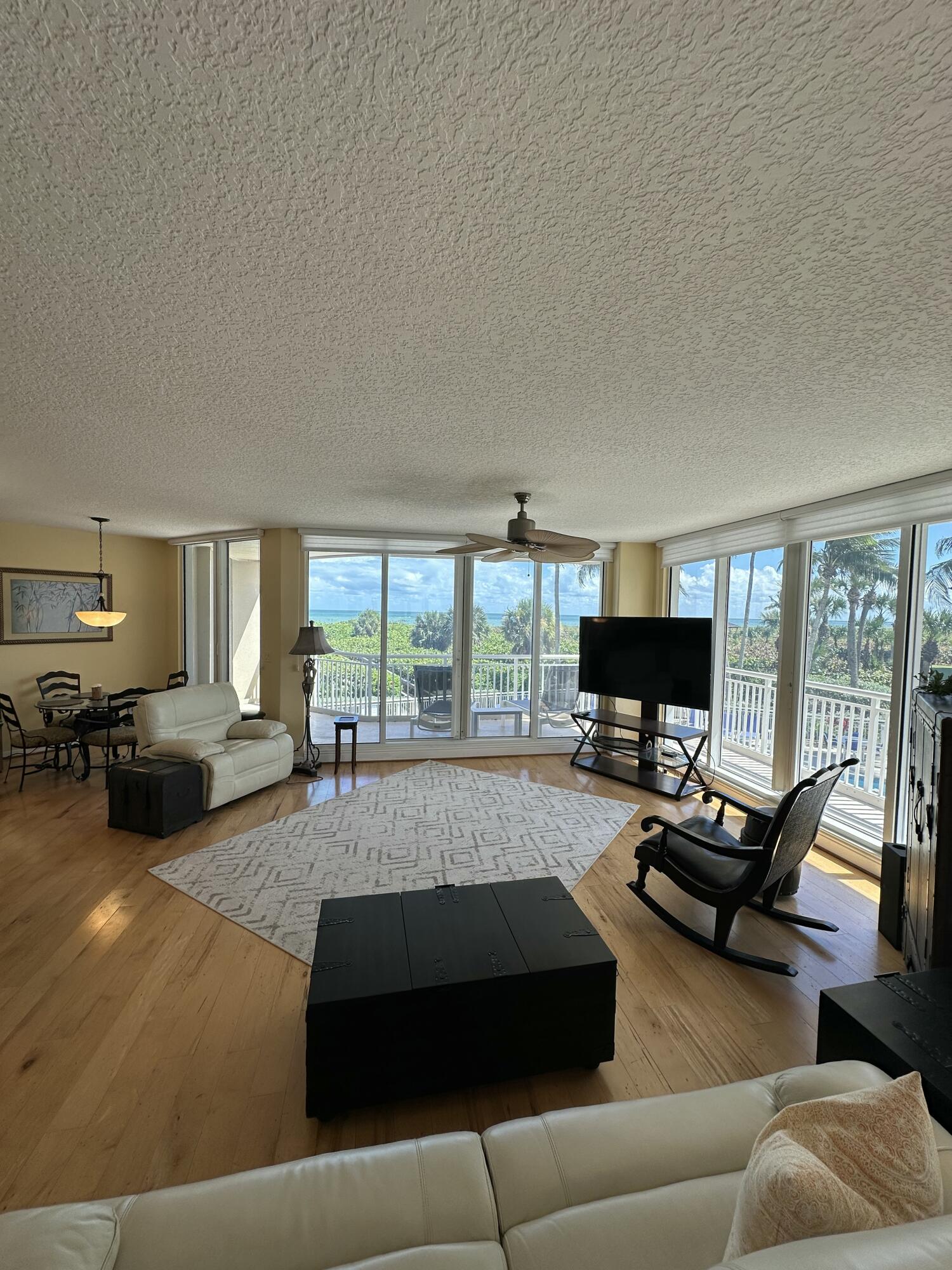 2900 North Hwy A1A, Unit 2 Fort Pierce, FL 34949 - Photo 2 of 34 a living room with furniture fireplace and a flat screen tv