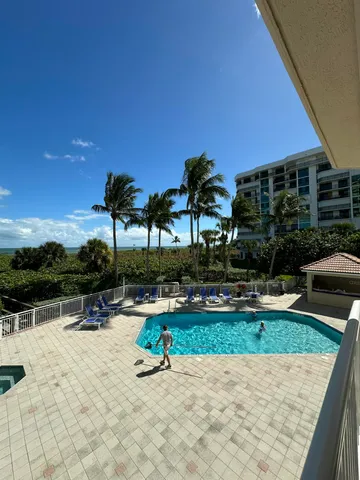 a view of swimming pool with seating area and barbeque oven