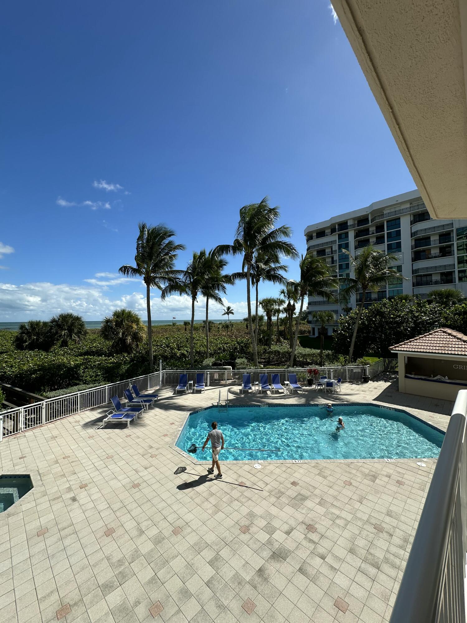 2900 North Hwy A1A, Unit 2 Fort Pierce, FL 34949 - Photo 21 of 34 a view of swimming pool with seating area and barbeque oven