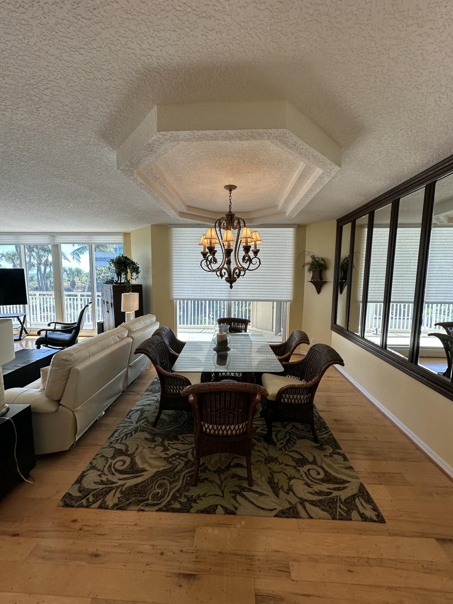 2900 North Hwy A1A, Unit 2 Fort Pierce, FL 34949 - Photo 25 of 34 a living room with furniture and a chandelier