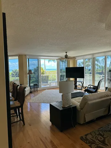 a living room with furniture fireplace and a large window