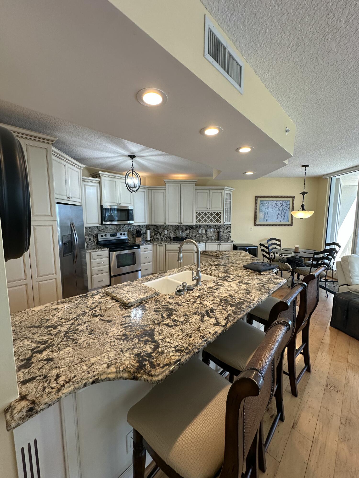 2900 North Hwy A1A, Unit 2 Fort Pierce, FL 34949 - Photo 3 of 34 a view of a dining area kitchen island stainless steel appliances refrigerator sink and dining table