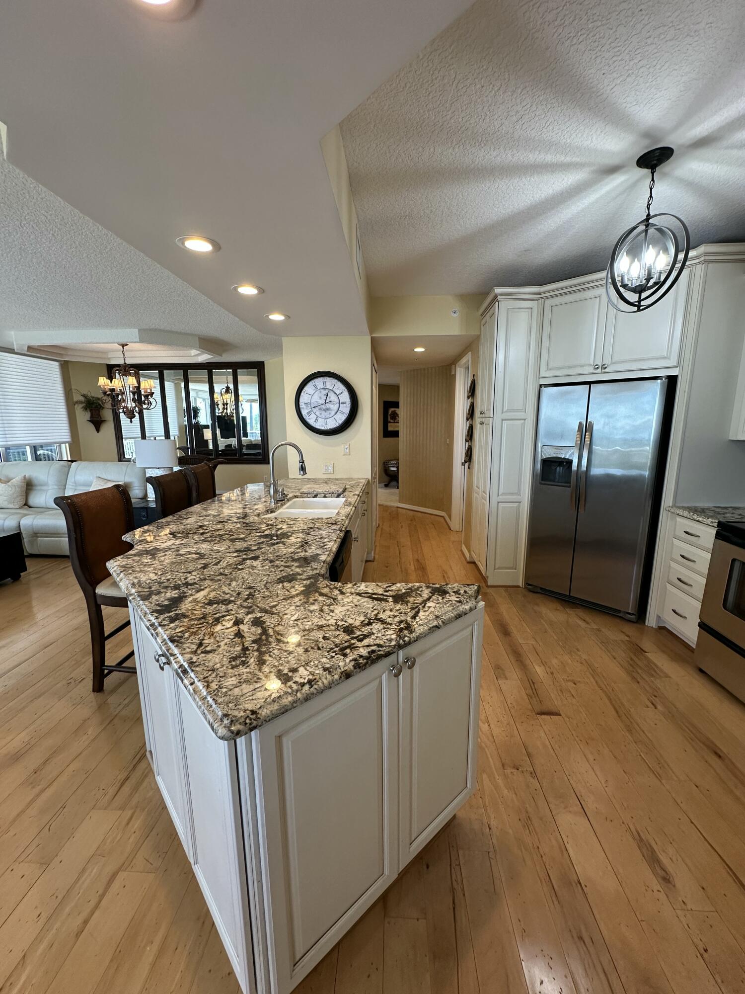 2900 North Hwy A1A, Unit 2 Fort Pierce, FL 34949 - Photo 4 of 34 a kitchen with stainless steel appliances granite countertop a sink stove and wooden floor