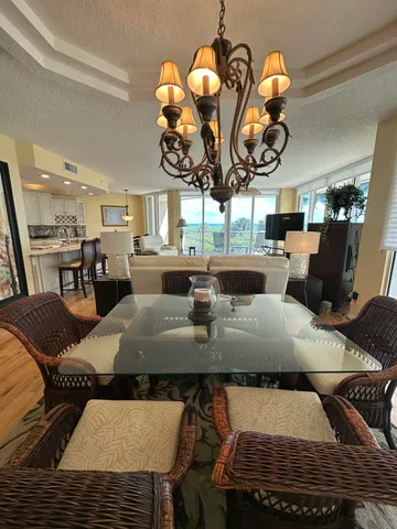 a view of a dining room with furniture wooden floor and chandelier