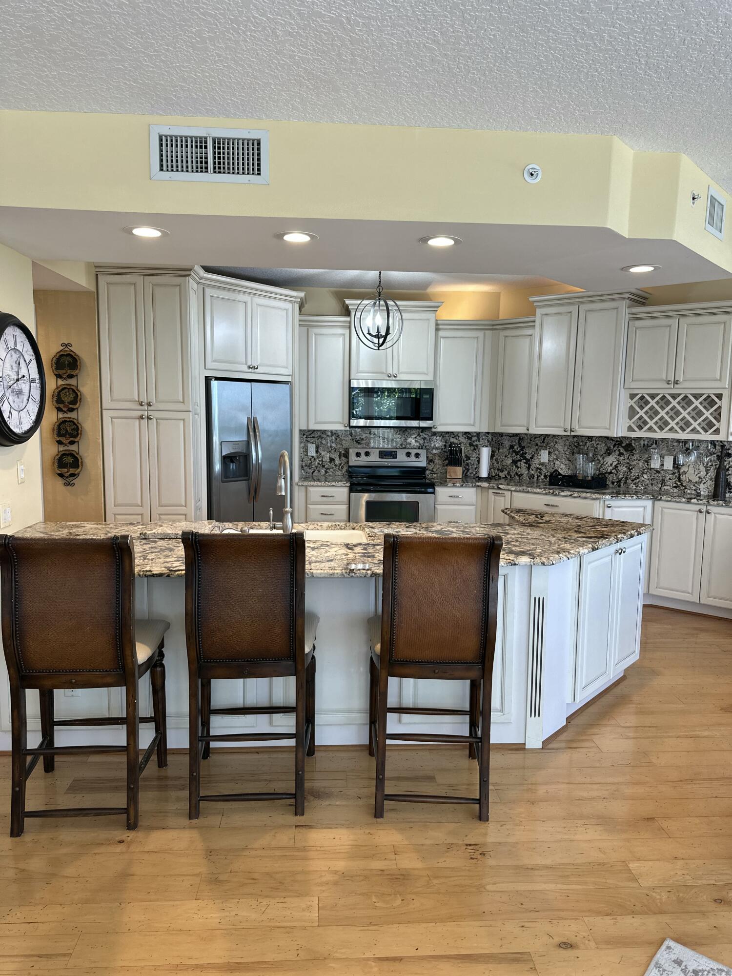 2900 North Hwy A1A, Unit 2 Fort Pierce, FL 34949 - Photo 8 of 34 a kitchen with a table chairs sink and cabinets