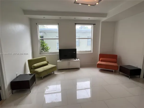 a living room with furniture and a window