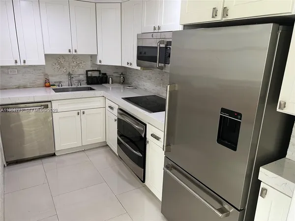 a kitchen with a stove microwave and sink