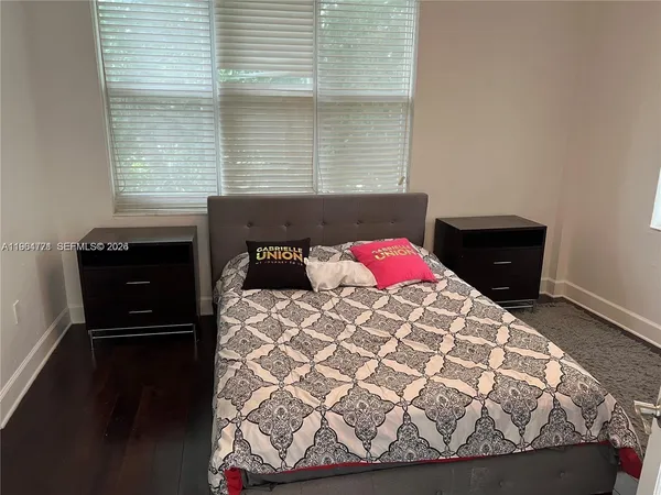 a bedroom with a bed and window