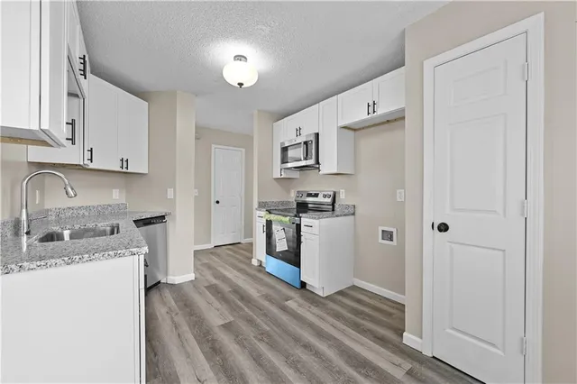 a kitchen with a refrigerator stove and sink