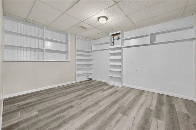 a view of walk in closet with empty racks