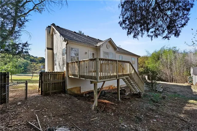 a view of a house with backyard and sitting area