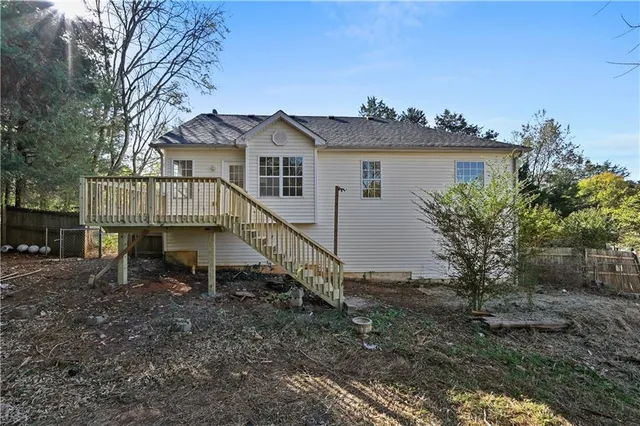 a view of a house with a yard and a tree