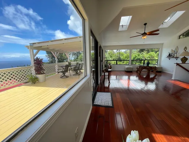 a view of a chairs and table in patio with a wooden fence