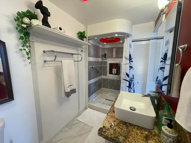 a view of a bathroom with a sink and a mirror