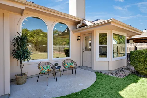 an empty room with a window and a ceiling fan