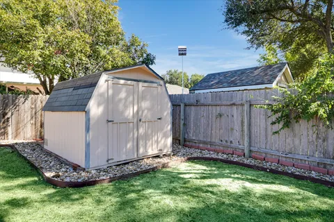a front view of a house with a garden and yard