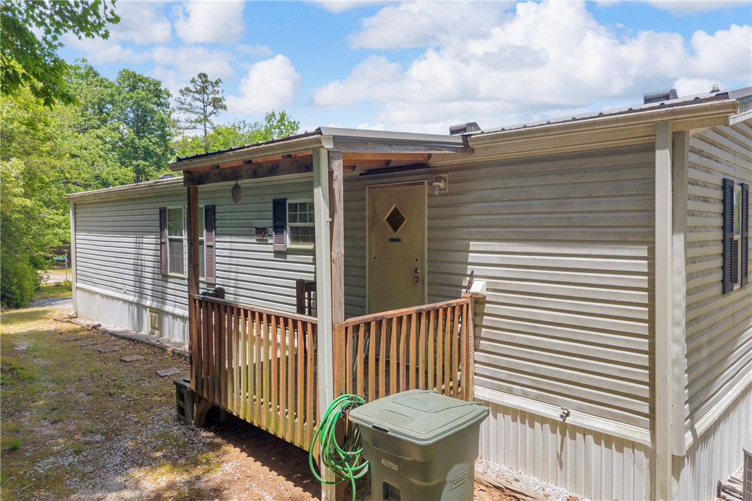 334 Lake Becky Road Mountain Rest, SC 29664 - Photo 43 of 46 A well-maintained manufactured home nestled amidst lush greenery offers comfortable living.