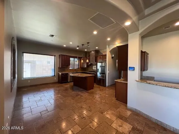 a living room with a wooden floor and a sink