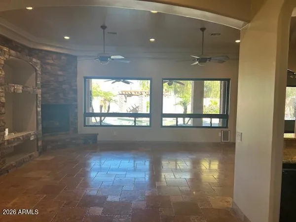 a view of empty room with floor to ceiling windows