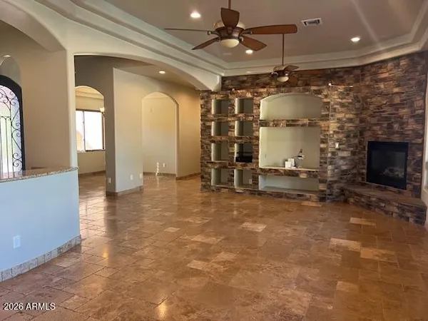 a view of a livingroom with a fireplace and a chandelier